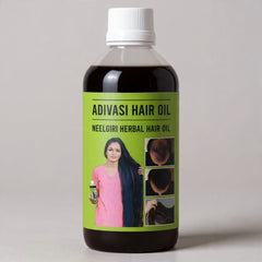 Bottle of Adivasi Hair Oil with a green label featuring a woman and images of hair.