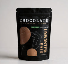 Package of chocolate hair removal powder on a light gray background