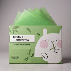 Box of Timify & Green Tea oil-absorbing paper with a cartoon character on a gray background